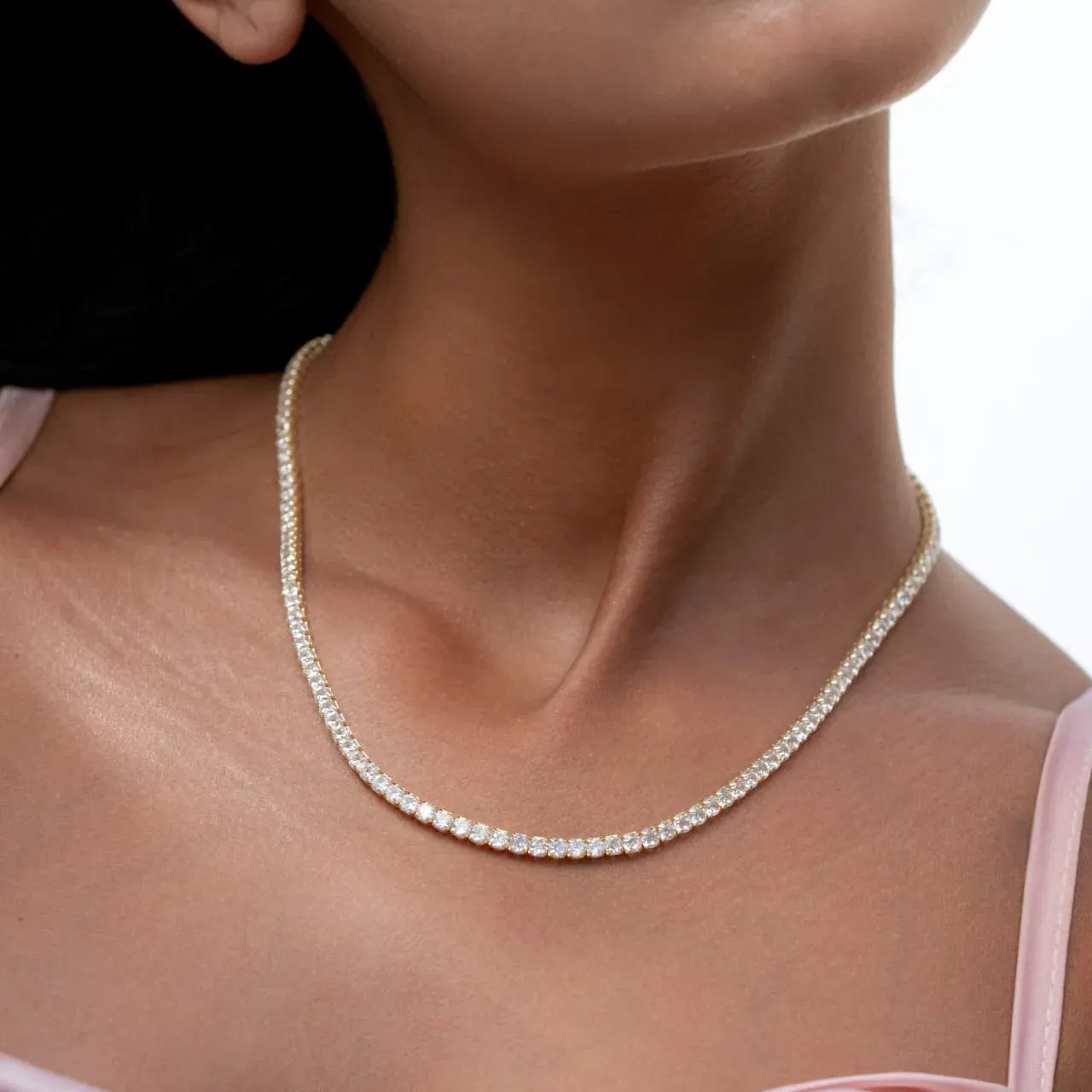 Model with pink outfit wearing Elme Classic Tennis Necklace in sterling silver